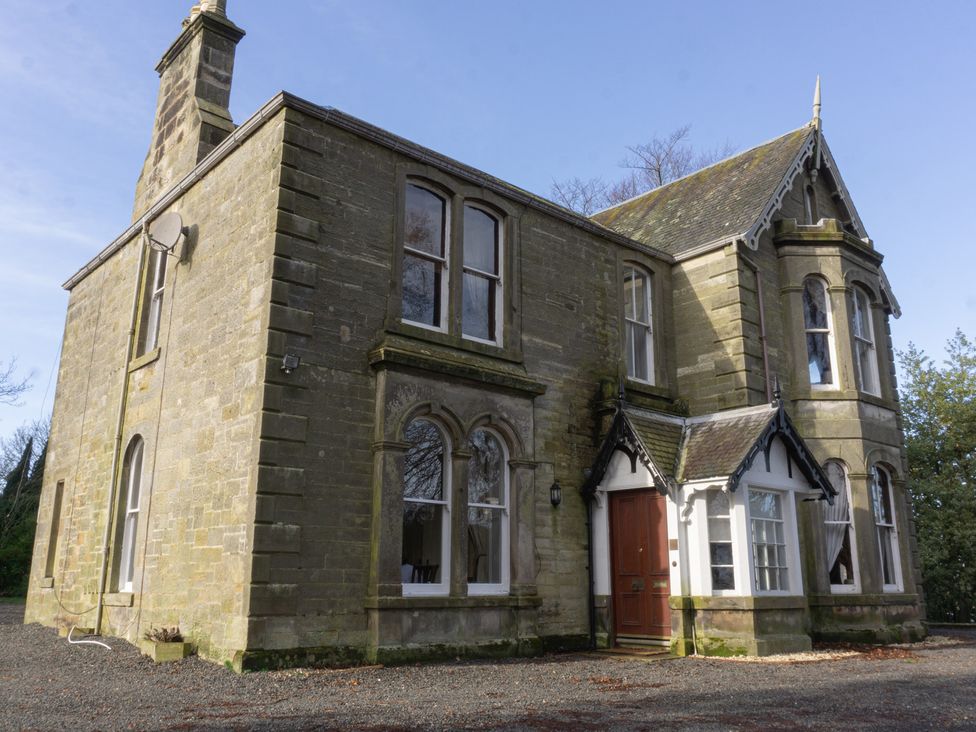 A large stone house with multiple windows and a front door at Newton Manor House in Cupar