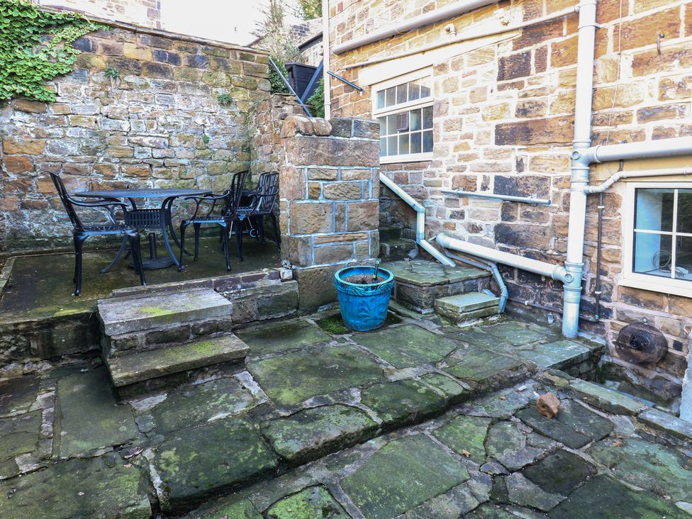 A patio with a table and chairs at Lake side cottage 