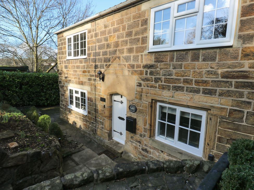 A stone wall with a door and windows at Lake side cottage