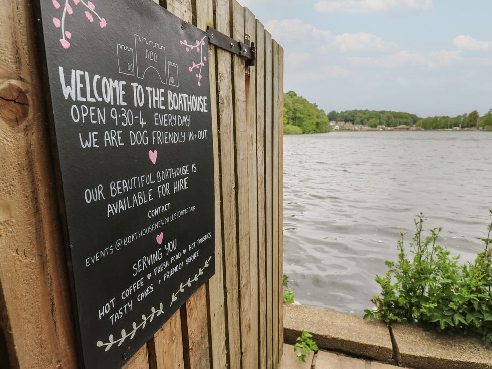 A sign at a boathouse near the water at Lake side cottage