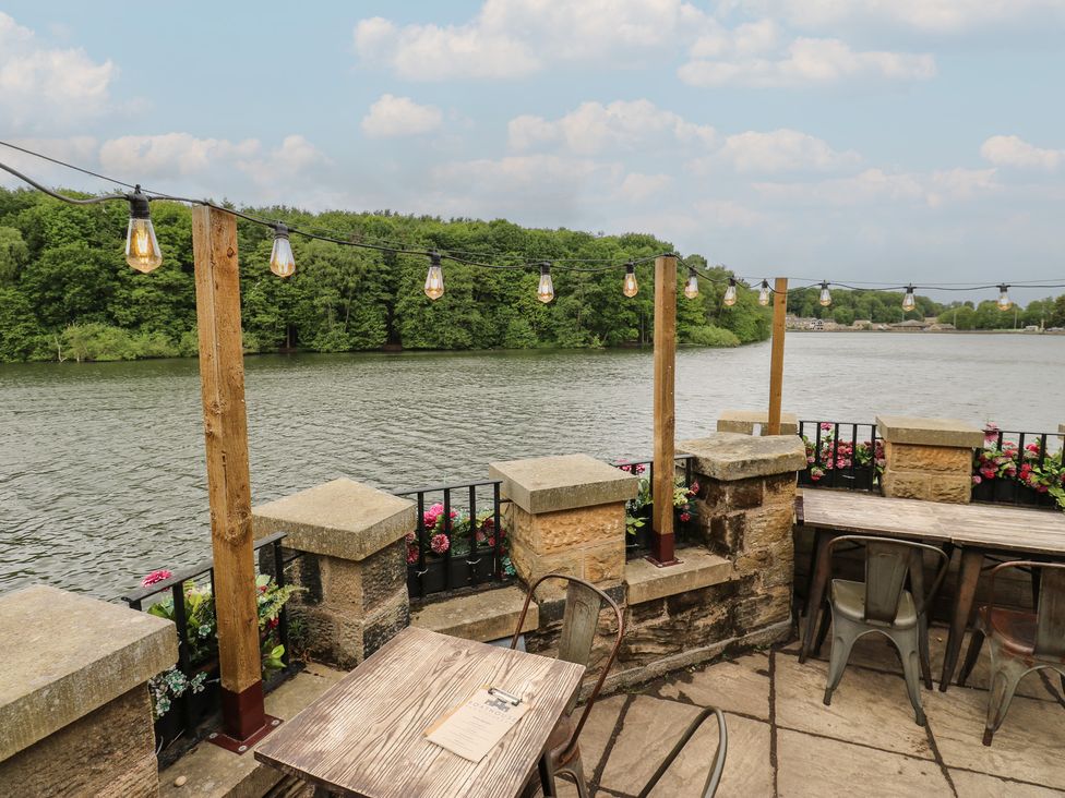 An outdoor seating area by the water at Lake side cottage