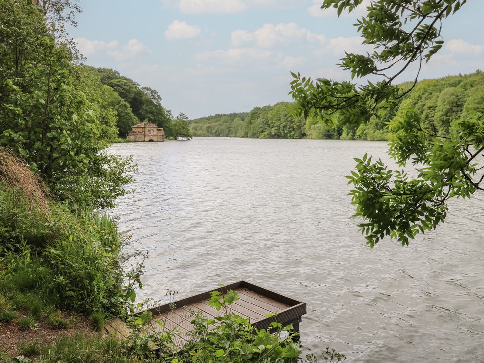 A view of a lake with trees and a dock at Lake side cottage in 