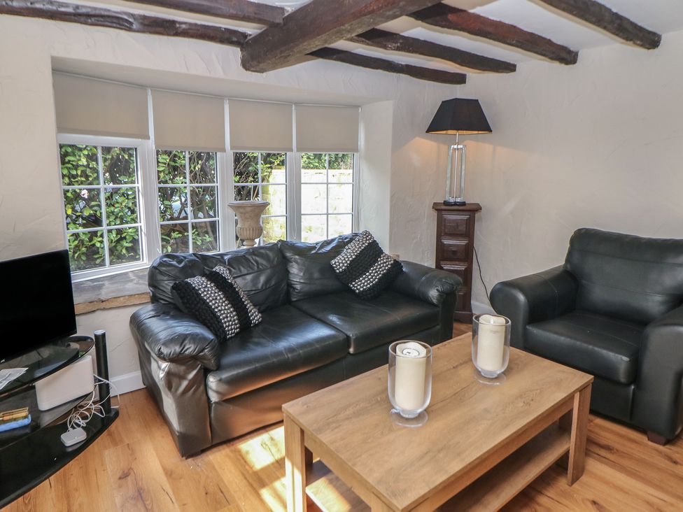 A living room with a sofa and armchair at Lake Side Cottage in Wakefield