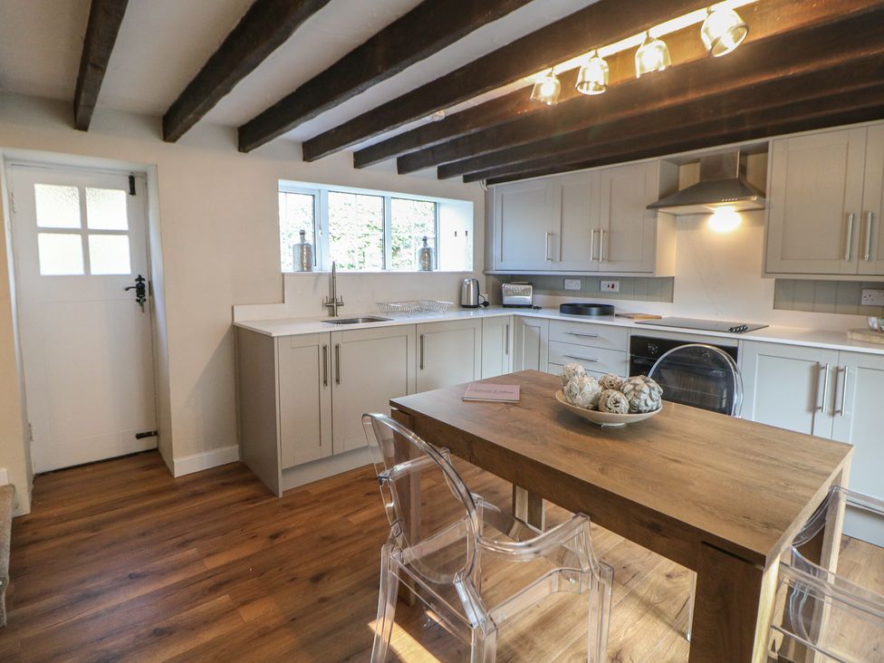 A kitchen with a table and chairs at Lake Side Cottage in Wakefield