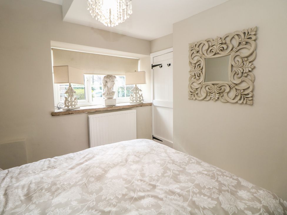 A bedroom with a bed and a window at Lake Side Cottage in Wakefield