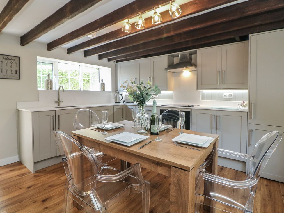 A kitchen with table and chairs at Lake Side Cottage in Wakefield