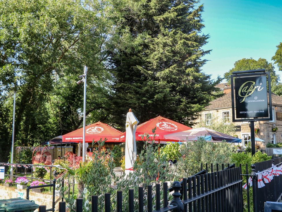 An outdoor dining area with umbrellas and flowers at Capri restaurant in New Millerdam