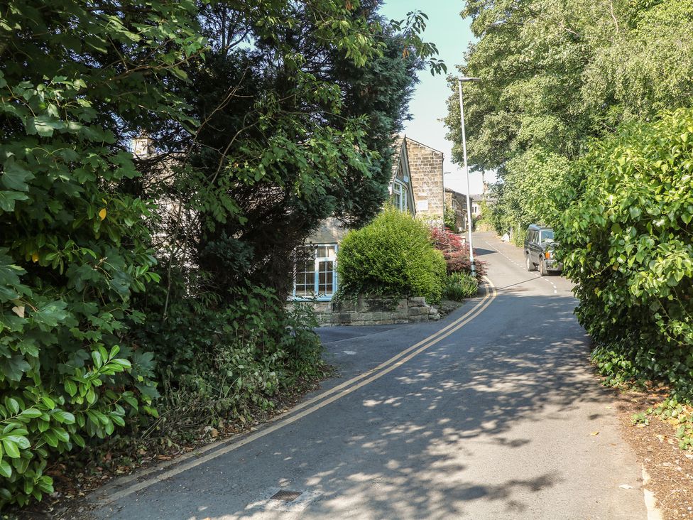 A road with trees and bushes at Lake Side Cottage in Wakefield