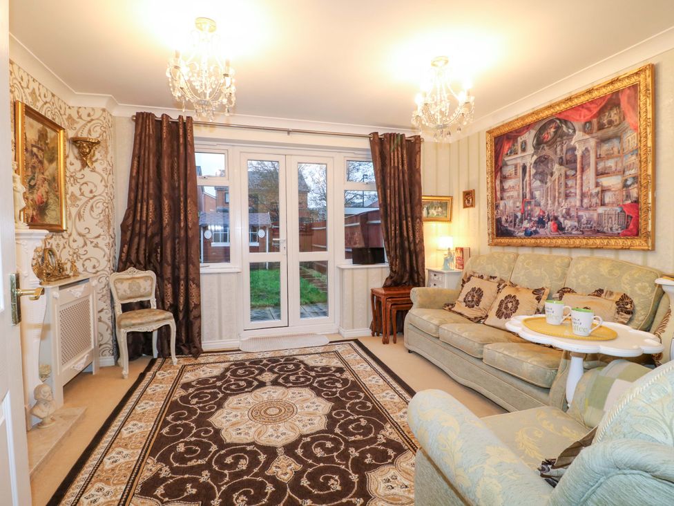 A living room with a sofa and curtains at 41 Lower Birches Way Rugeley