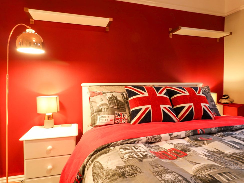 A bedroom with a bed and nightstand at 41 Lower Birches Way, Rugeley