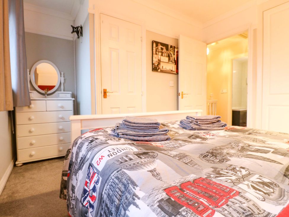 A bedroom with a bed and a dressing table at 41 Lower Birches Way Rugeley