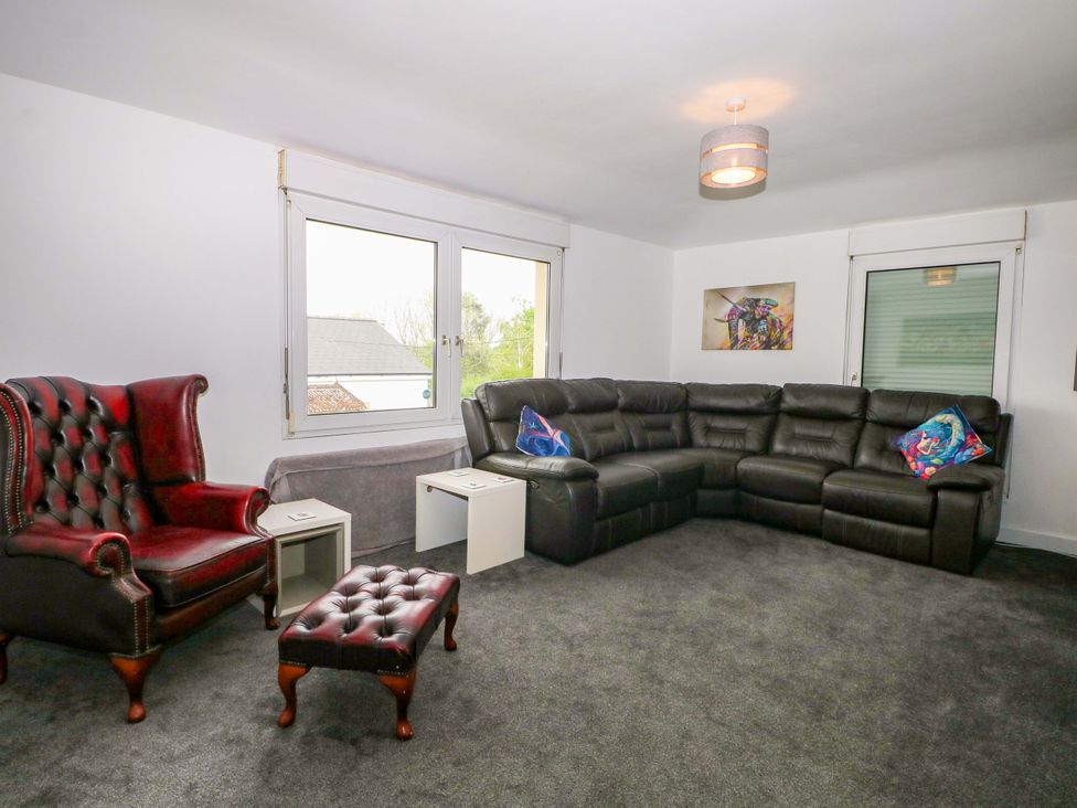 A living room with an armchair and a sofa at Woodside in Battle