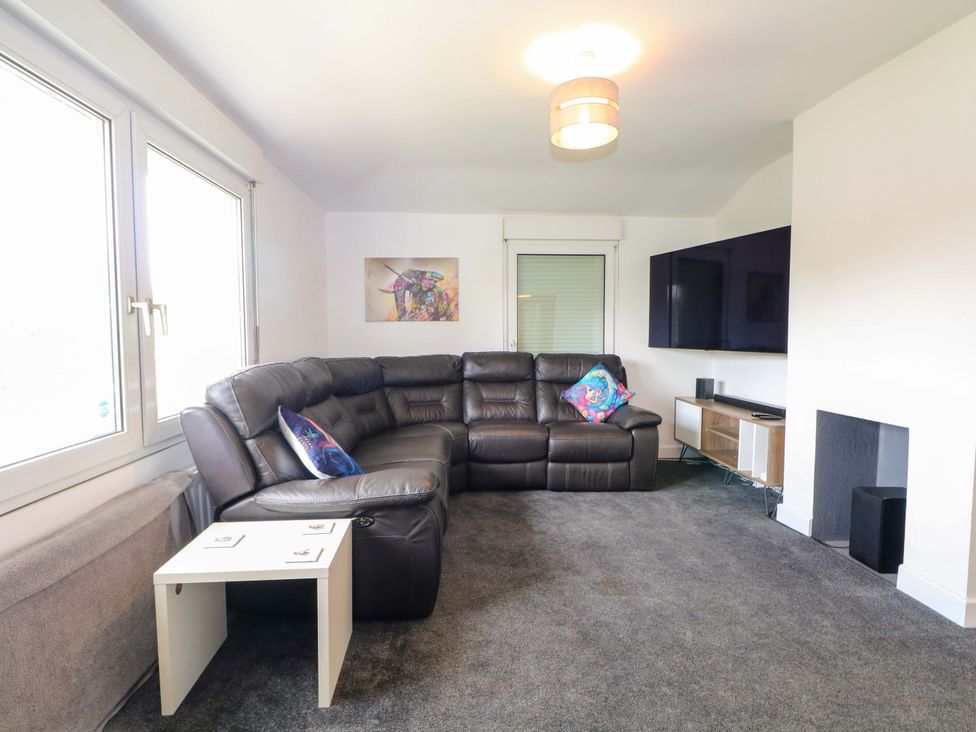 A living room with a sofa and television at Woodside in Battle