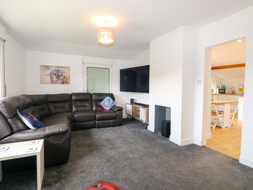 A living room with a sofa and television at Woodside in Battle