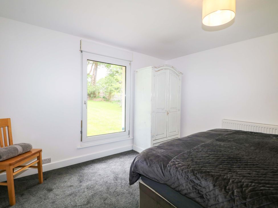 A bedroom with a bed and wardrobe at Woodside in Battle