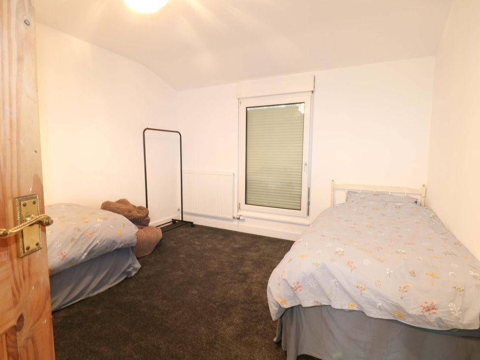 A bedroom with two beds and a window at Woodside in Battle