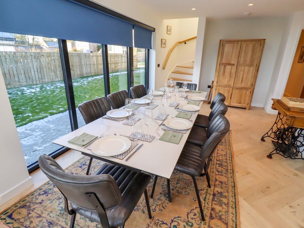 A dining room with a table set for a meal at 1 Dairy Fields Longframlington