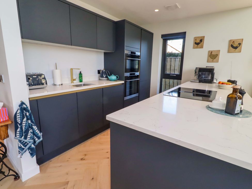 A kitchen with modern appliances and a countertop at 1 Dairy Fields Longframlington