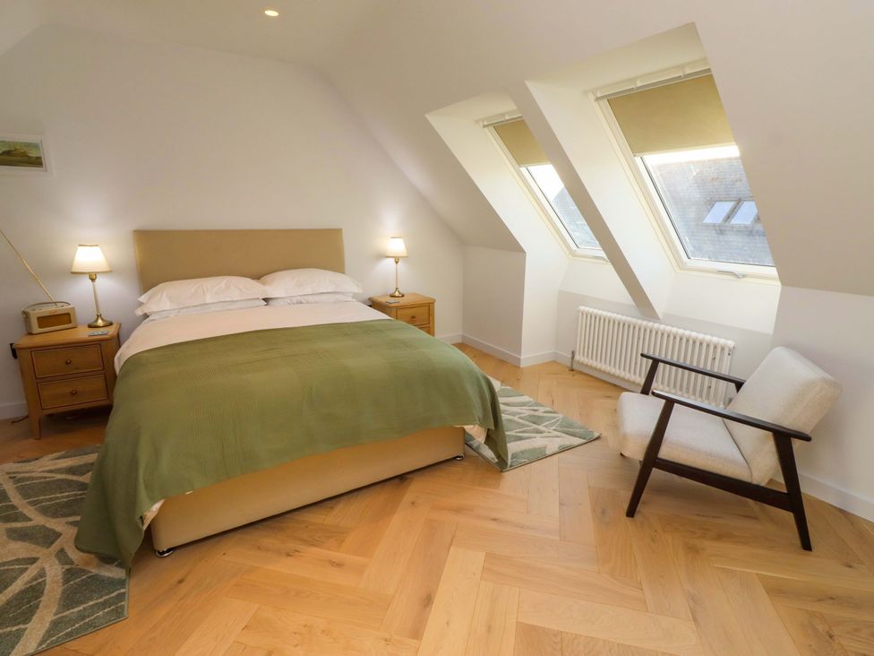 A bedroom with a bed and nightstand at 1 Dairy Fields Longframlington