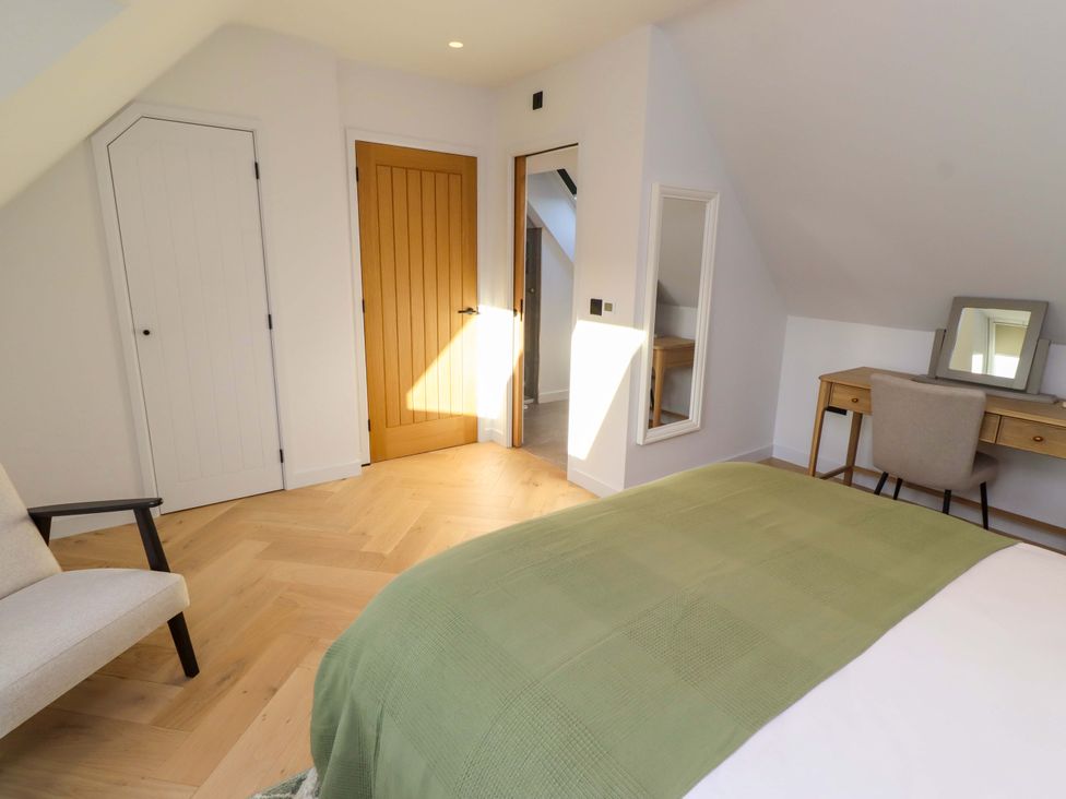 A bedroom with a bed, chair, and desk at 1 Dairy Fields Longframlington