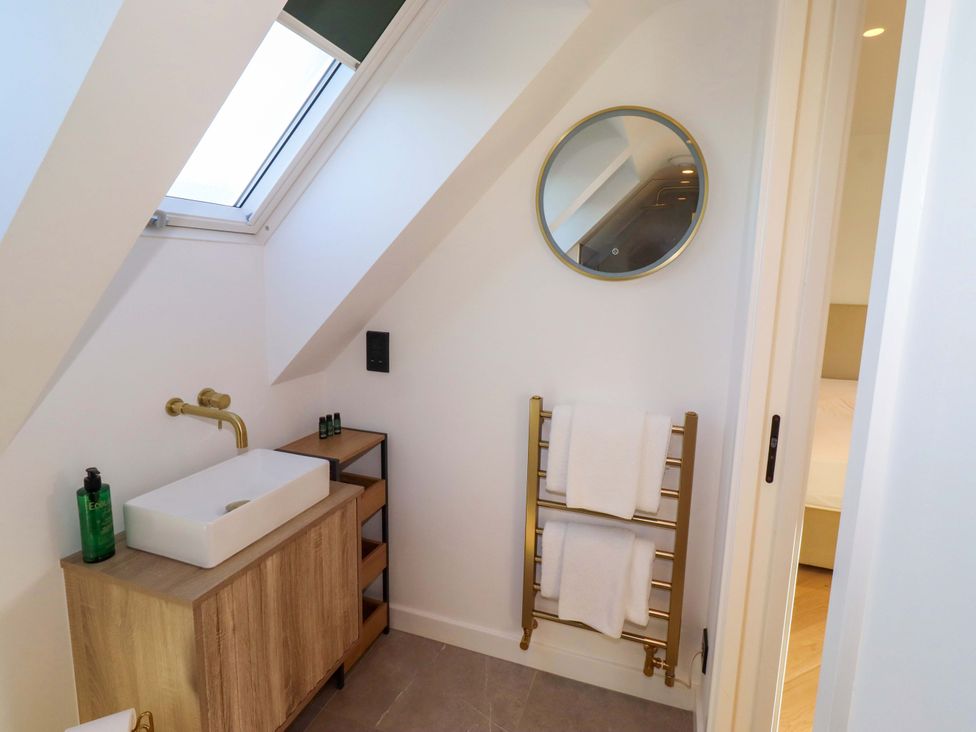 A bathroom with a sink and towel rack at 1 Dairy Fields in Longframlington