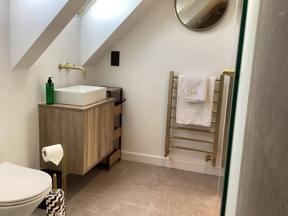 A bathroom with a sink and towel rack at The Barn in Longframlington
