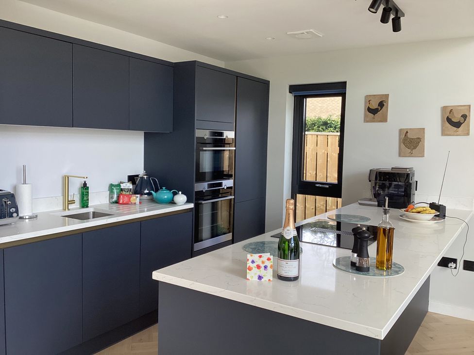 A kitchen with cabinets, countertop, and appliances at The Barn in Longframlington