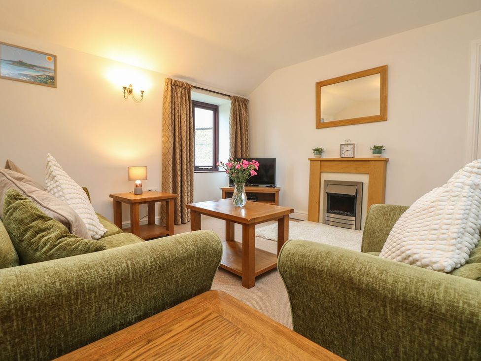A living room with a sofa and coffee table at Little Tregarrick in Helston