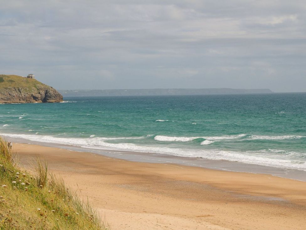 A beach with ocean waves and sand at Little Tregarrick in Helston