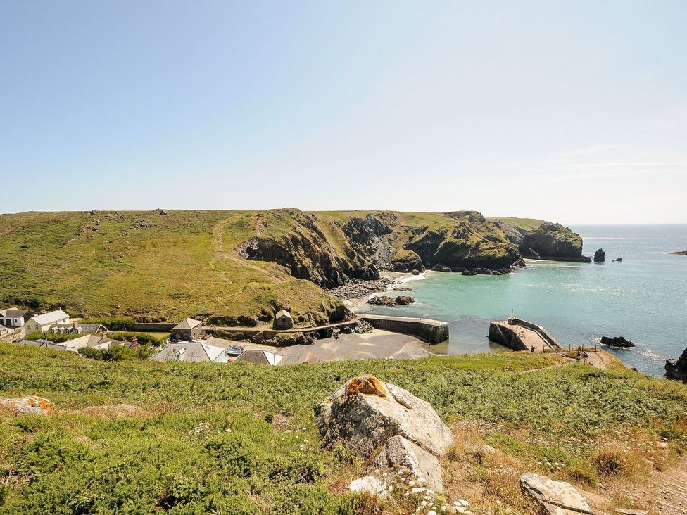 A coastal view with water and rocky land at Little Tregarrick in Helston