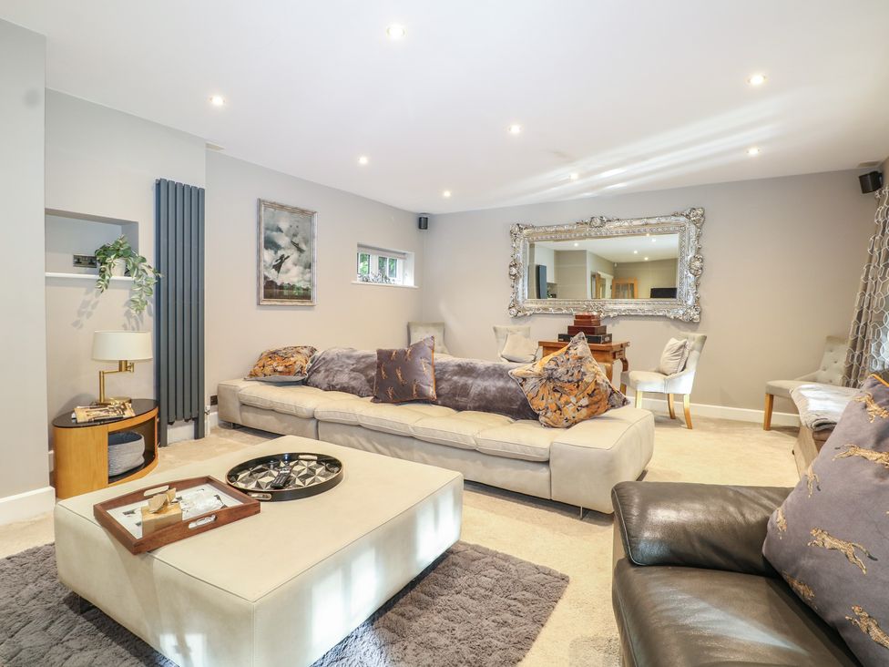 A living room with a sofa and coffee table at Woodlands house in Ringwood