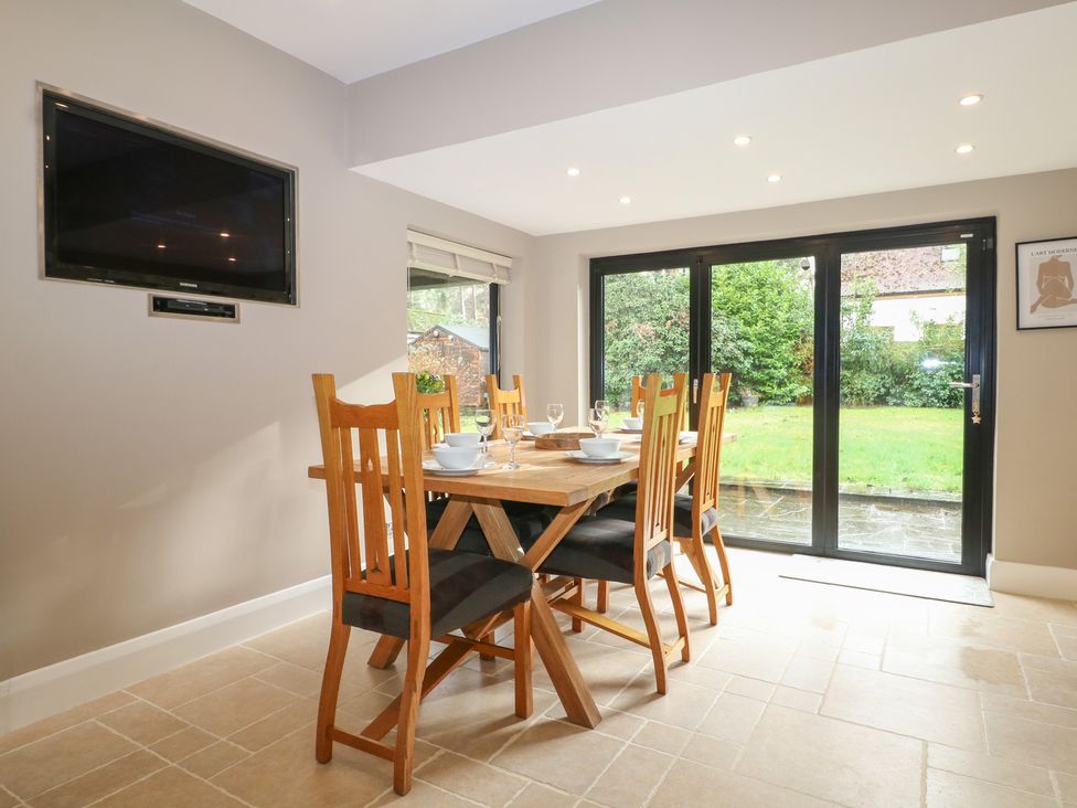 A dining room with a table and chairs at Woodlands house in Ringwood