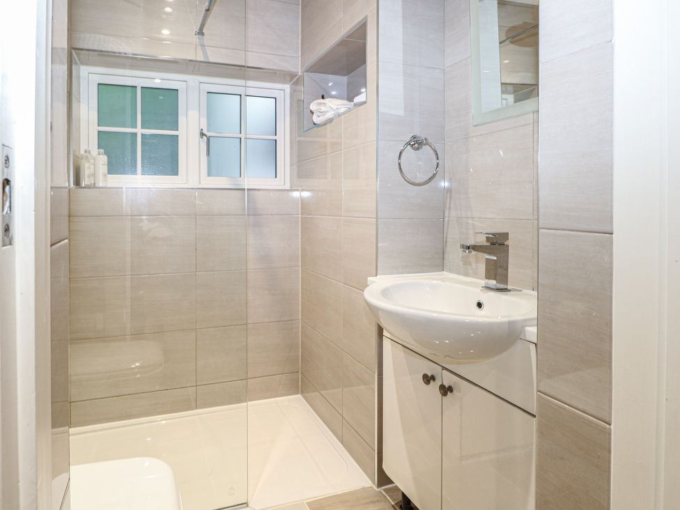 A bathroom with a sink and shower at Woodlands house in Ringwood