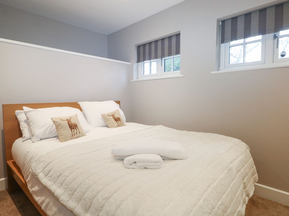 A bedroom with a bed and pillows at Woodlands house in Ringwood