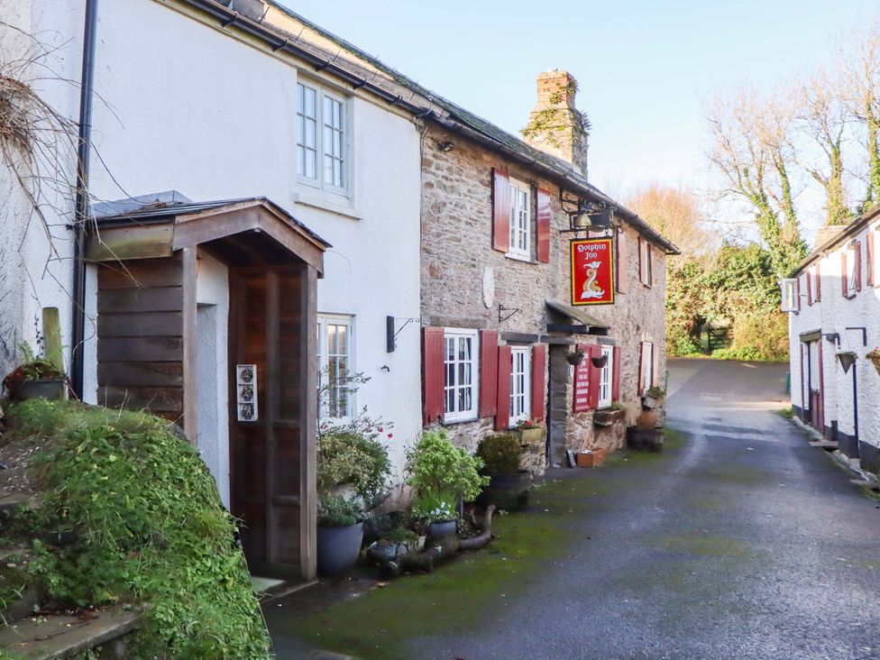 A building exterior with a front door and sign at Park Cottage in Kingsbridge