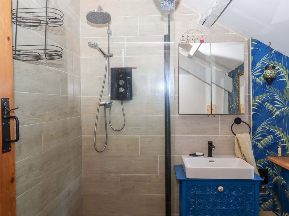 A bathroom with a shower and sink at Park Cottage in Kingsbridge