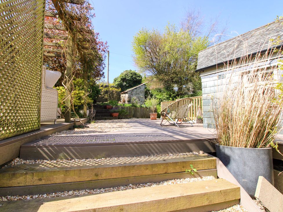 A garden with wooden steps and a deck at Park Cottage in Kingston, Kingsbridge