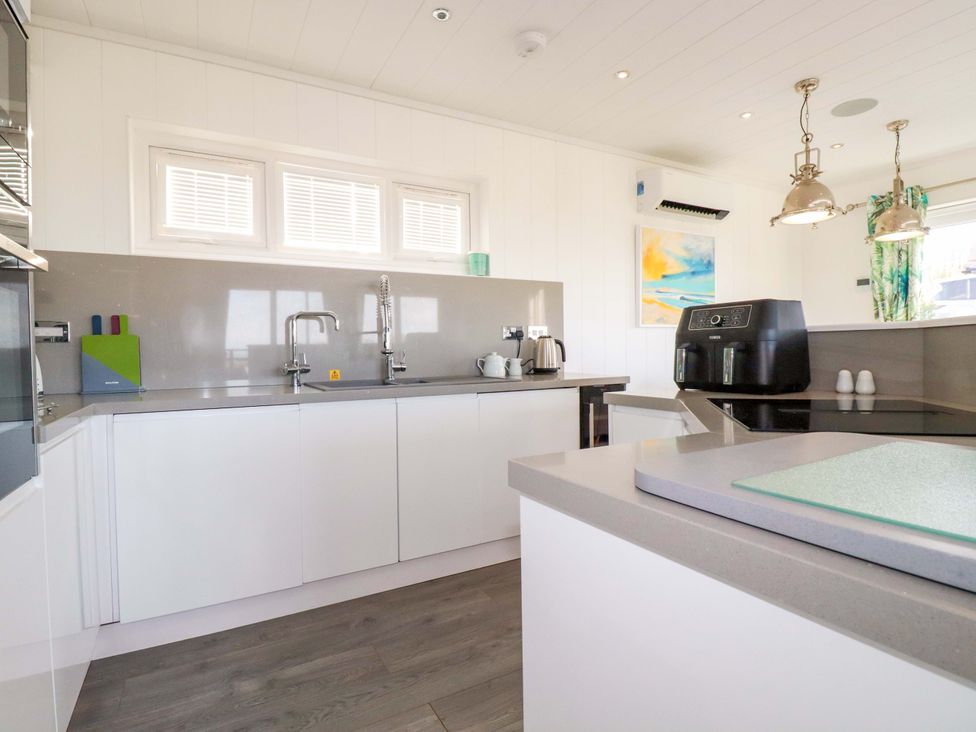 A kitchen with a sink and air fryer at 114 - The Residance Redruth