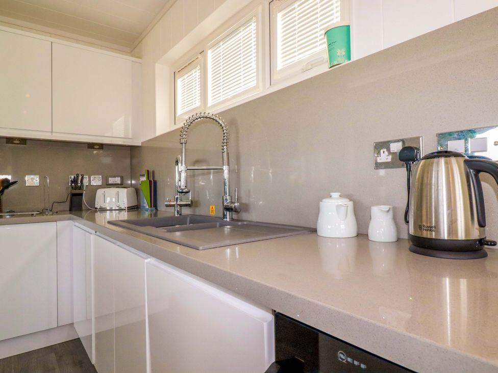 A kitchen with a sink, kettle, and other kitchen appliances at 114 - The Residance in Redruth