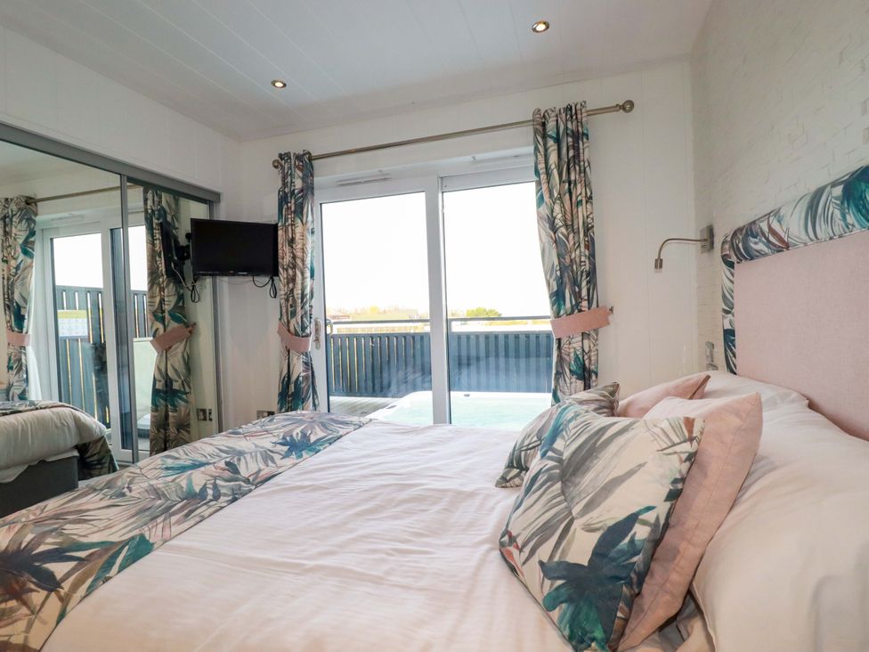 A bedroom with a bed and television at 114 - The Residance in Redruth