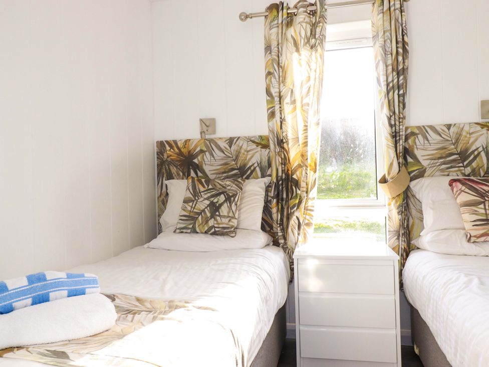 A bedroom with two beds and a window at 114 - The Residance in Redruth