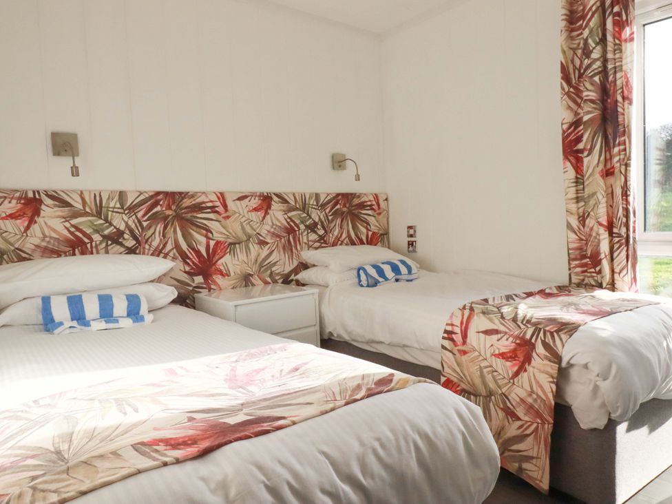 A bedroom with two beds and a window at 114 - The Residance in Redruth