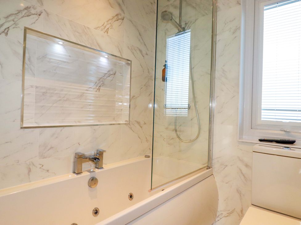 A bathroom with a bathtub and shower in Redruth