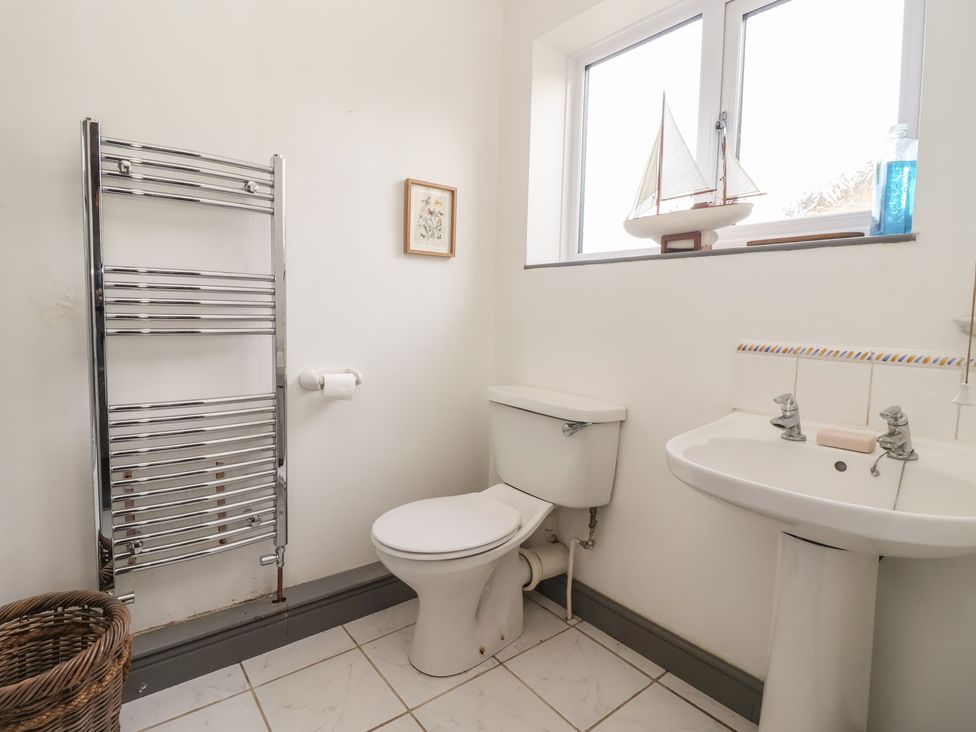 A bathroom with a toilet and sink at Mallard Cottage in Nafferton