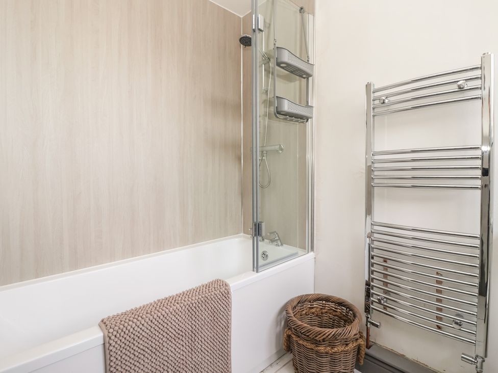 A bathroom featuring a bathtub and shower unit at Mallard Cottage Nafferton