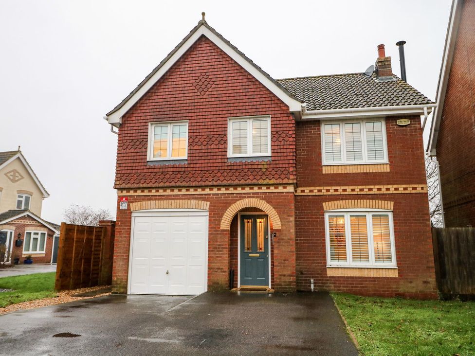 A house with a garage and pathway in front at Number 5