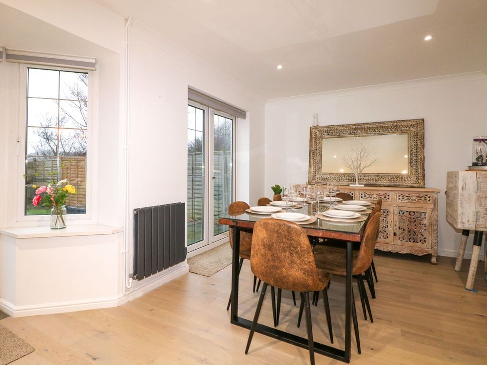 A dining room with a table set for dinner at Number 5