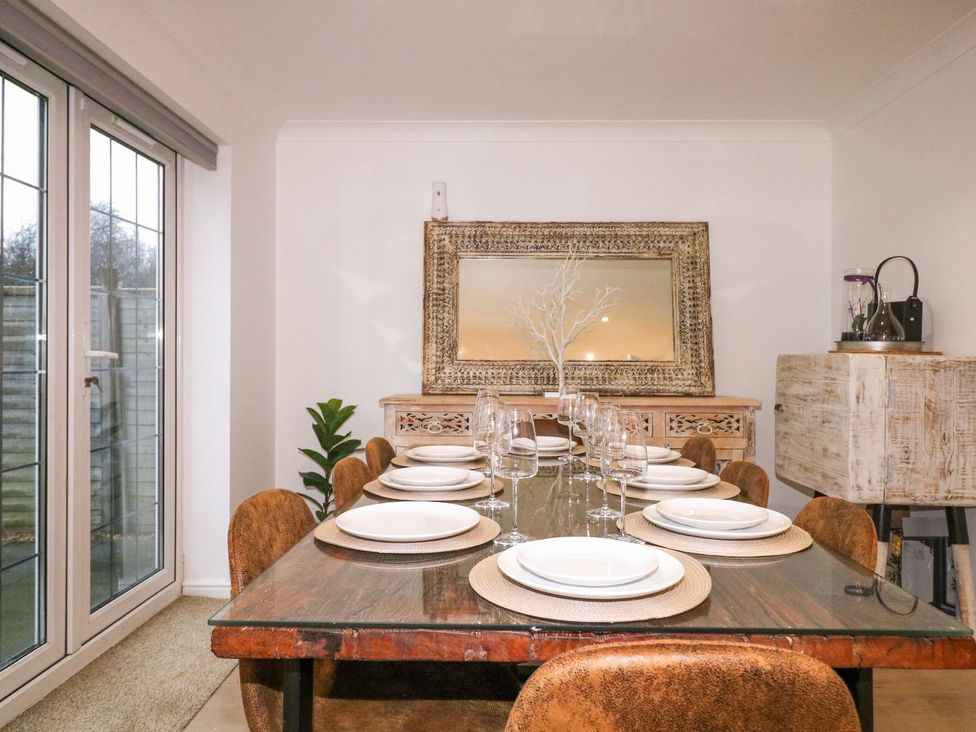 A dining room with a table set for dinner at Number 5