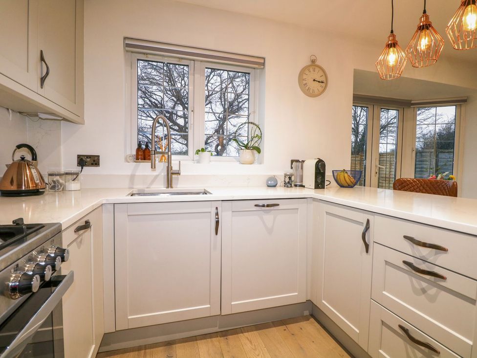 A kitchen with a sink and coffee machine at Number 5