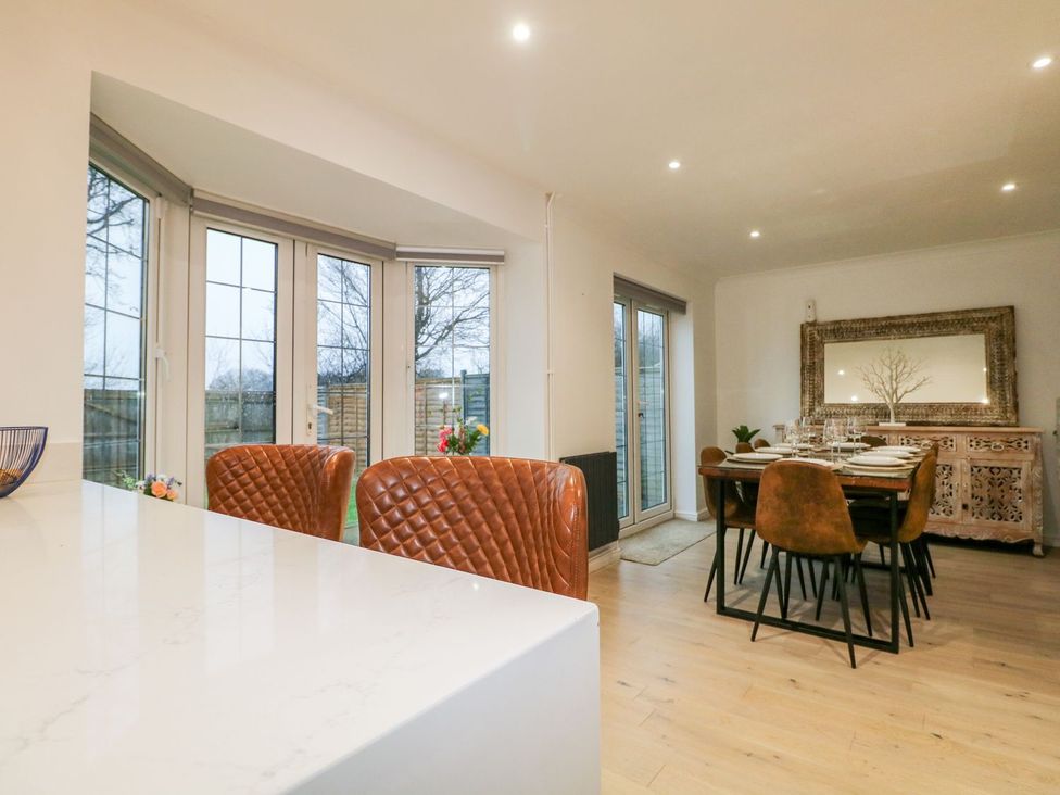 A dining area with a table and sideboard at Number 5